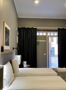 a bedroom with a bed and a sliding glass door at Unique Hotel in Stockholm