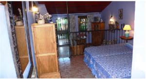 a bedroom with a bed with a blue bedspread at Cortijo Zalamea in Zalamea la Real