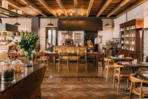 a restaurant with tables and chairs in a room at Rooms Hotel Tbilisi in Tbilisi City