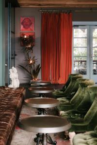 a row of tables and chairs in a room at Rooms Hotel Tbilisi in Tbilisi City
