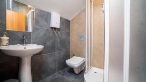 a bathroom with a white sink and a toilet at Vera Park Premium Apart Hotel in Antalya +58 photos