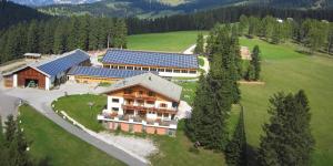 an aerial view of a building with solar panels on it at Angerle Alm Apt König Laurin in Carezza al Lago
