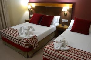 Posteľ alebo postele v izbe v ubytovaní Hotel Regio 2