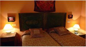 A bed or beds in a room at Cortijo Zalamea