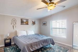 a bedroom with a bed and a ceiling fan at Resting Wildflower in Gunnison