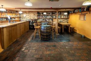 a bar with a barrel in the middle of a room at The Wayside and Whisky Barn in Whitbeck