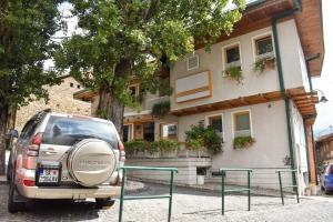 a car parked in front of a house at Hotel Kovači in Sarajevo