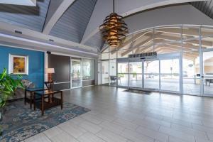 a large room with a lobby with a table and glass doors at Oceanfront Studio Condo With Balcony View Of Beach And Ocean In Daytona Beach Resort 1011 With 4 Pools Tiki Bar Grill in Daytona Beach