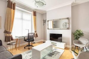 a living room with a couch and a table at The Summit Apartment Holburn - Lovely 1 bedroom in Aberdeen