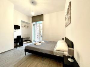 a bedroom with a bed and a desk in it at Colosseum Guest House in Rome