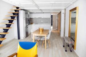 a kitchen and dining room with a table and chairs at Lovely Duplex in Seville