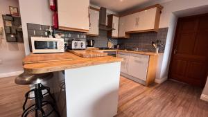 a kitchen with a counter with a microwave on it at Beachcombers Apartments in Newquay