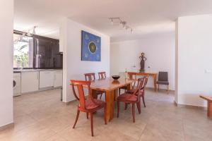 eine Küche und ein Esszimmer mit einem Holztisch und Stühlen in der Unterkunft 3h La Quinta - Wonderful 4 Bed Villa Wth Pool in San Miguel de Abona