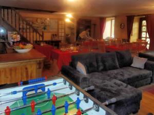 a living room with a ping pong table at La Merveille in Le Luot