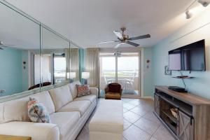 a living room with a couch and a flat screen tv at Jetty East A516 in Destin