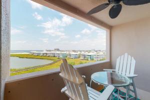 a balcony with a table and chairs and a view of the ocean at Jetty East A516 in Destin