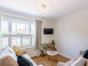 a living room with a couch and a large window at Eves Retreat in Wragby