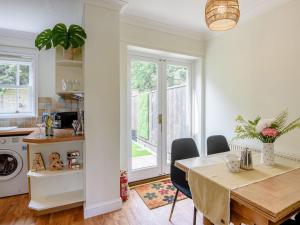 a kitchen and dining room with a table with chairs at Eves Retreat in Wragby