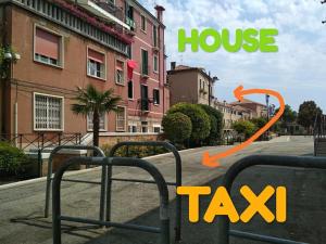 a picture of a house and a taxi sign on a street at Artist House in Venice