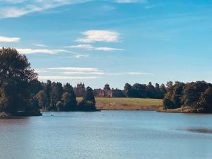 a view of a lake with a castle in the background at Detached annex in centre of Woodstock, Cotswolds in Woodstock