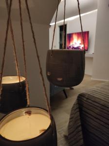 ein Wohnzimmer mit zwei Hängelampen und einem Kamin in der Unterkunft Piervì Suite in Putignano