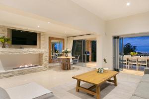 a living room with a fireplace and a tv at Lyons Den - No Load Shedding in Cape Town