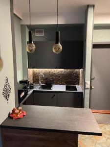 a kitchen with a sink and a counter top at Apartament Cud Miód in Kościelisko +10 photos