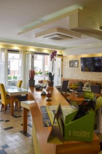 a living room with a table and chairs at Hotel Kovači in Sarajevo