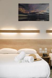 a hotel room with a bed with a hat on it at Calma Beach Hotel in Stavros