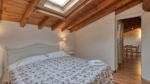 a bedroom with a bed and a skylight at Cascina Volta in Brescia