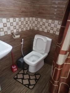 a small bathroom with a toilet and a sink at Hortensia in Quatre Bornes