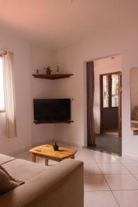 a living room with a couch and a table at Casa do Pepe in Cayru