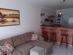 a living room with a couch and a bar at Meu Cantinho na Praia do Frances in Marechal Deodoro