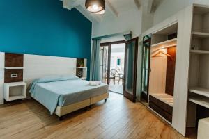 Postel nebo postele na pokoji v ubytování I Ginepri Hotel