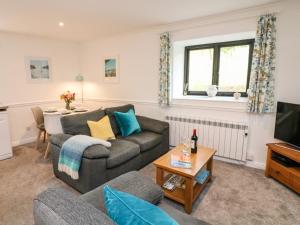 a living room with a couch and a table at Primrose at Stancombe Manor, Nr Kingsbridge in Kingsbridge