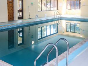 a large swimming pool with blue water in a building at Primrose at Stancombe Manor, Nr Kingsbridge in Kingsbridge