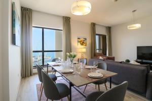 a living room with a table and chairs and a couch at HiGuests - Amazing Sea Views from this 2BR Apt in JBR in Dubai