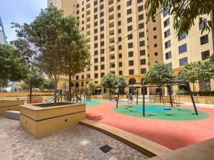 a playground in front of a large building at HiGuests - Amazing Sea Views from this 2BR Apt in JBR in Dubai