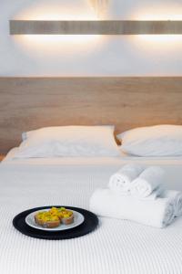 a plate of food on a bed with towels at Calma Beach Hotel in Stavros