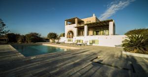 a large house with a swimming pool in front of it at Lithos Private Estate in Santa Maria