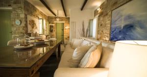 a living room with a couch and a table at Dream Villa Santa Maria in Santa Maria
