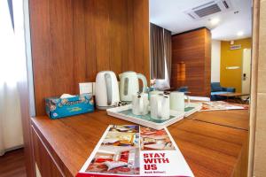 a hotel room with a desk with a magazine at CitiVilla Hotel Penang in George Town