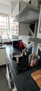 a kitchen with a stove with pots and pans on it at Location Location Location, Whole apartment for you! in London