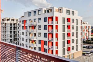 an apartment building with red and white windows at ARI Brownie Apartment in Arad