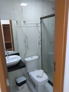 y baño con aseo, lavabo y ducha. en Pousada Sky Beach Flat en Porto De Galinhas