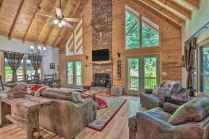 a living room with couches and a fireplace at Lavish Hiawassee Cabin - Great for Families! in Hiawassee