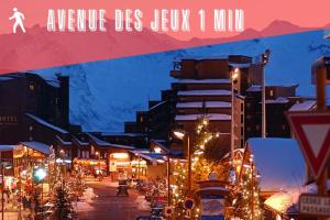 a city street with christmas trees and buildings at night at Studio des Jeux - Alpe d'Huez Hyper Centre - 4-5 personnes - Wifi in LʼHuez +9 photos
