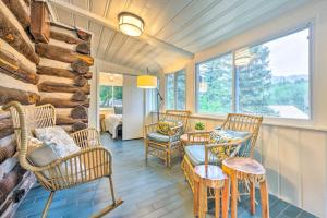 a room with wicker chairs and a table and a window at Charming Cascade Cabin about 1 Mi To Pikes Peak! in Cascade-Chipita Park