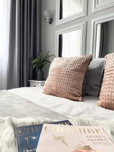 Apartment Studio PARIS 92 في إيربين: غرفة نوم بها سرير وكتبين عليها