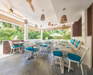 a dining room filled with tables and chairs at Bliss Dhigurah in Dhigurah